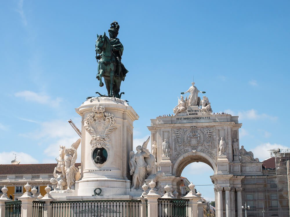 Statue of a man on horseback near a building in Lisbon, Portugal.