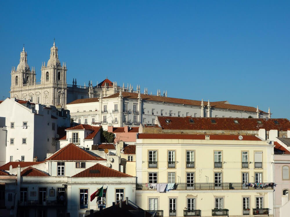 Aerial view of Lisbon, Portugal with a clear sky, buildings and historical landmarks.