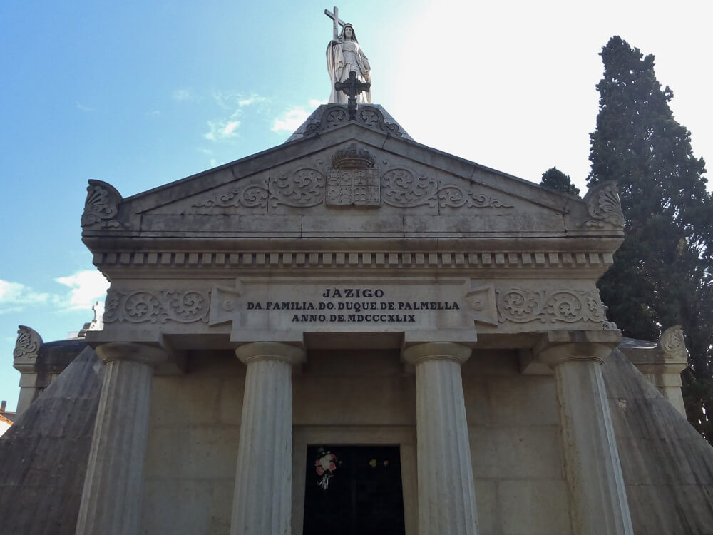 The majestic mausoleum of the Duke of Palmela family in Prazeres Cemetery, with its classical columns and stately façade.