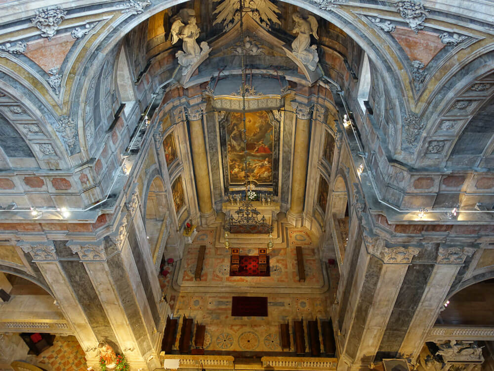 The interior of Basílica da Estrela, looking down from above, showing the altar and surrounding architecture.