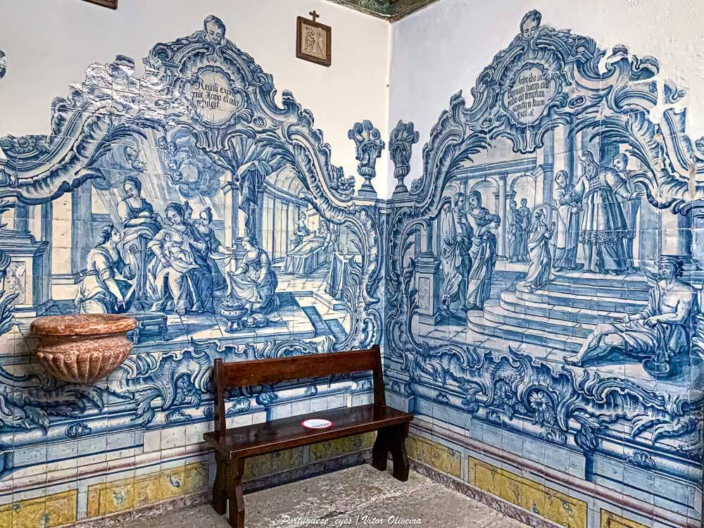 An intricate blue and white azulejo tile mural depicting biblical scenes on the walls of a historical building.