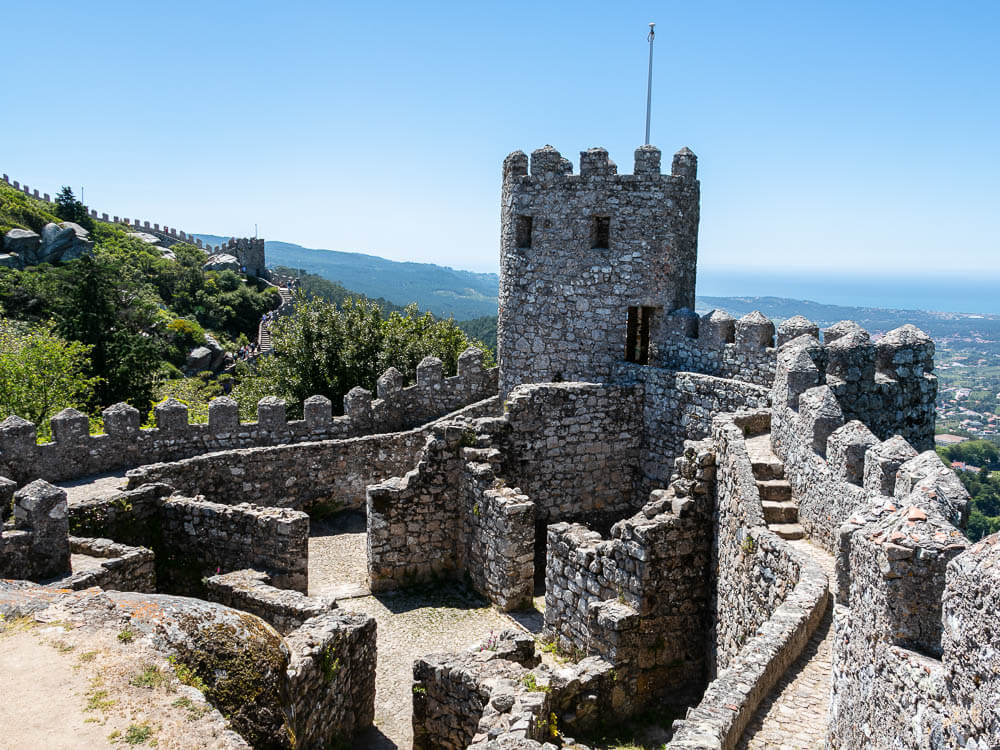 Stone tower and walls of the Castle of the Moors with battlements, providing a view of the surrounding landscape.