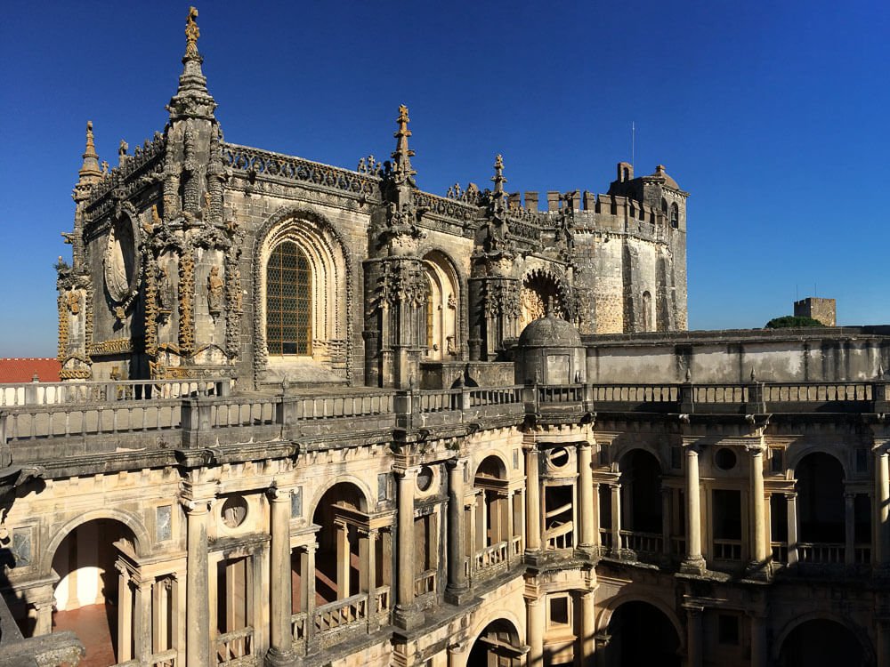 A panoramic view of the Convent of Christ's detailed architecture, highlighting the ornate Manueline-style decorations and arches.