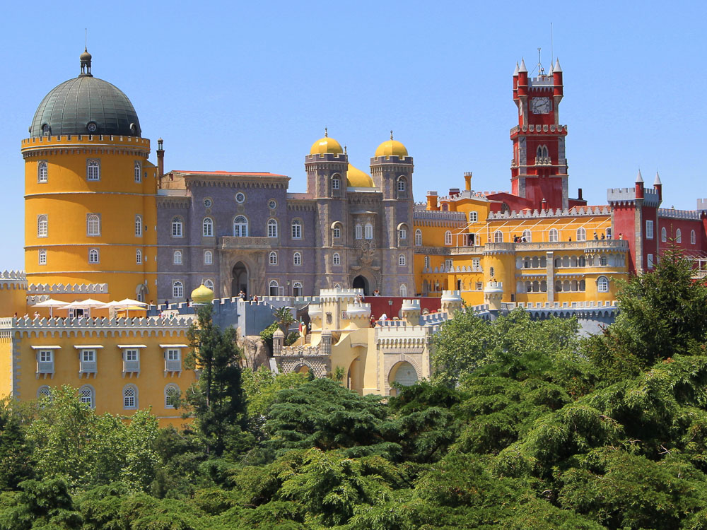 The colorful and iconic Pena Palace in Sintra, known for its vivid yellow and red colors and unique architectural style.