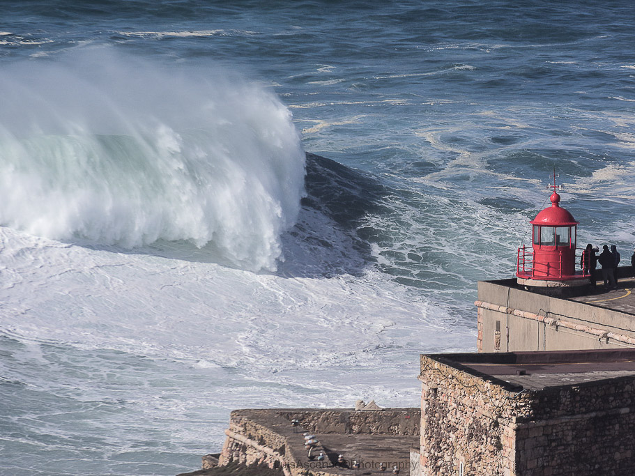 A dramatic scene of a giant wave crashing near a lighthouse, capturing the power of the ocean.