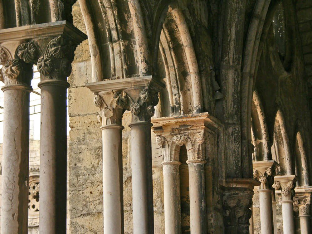 Close-up of intricately carved stone columns and arches inside the Lisbon Cathedral.